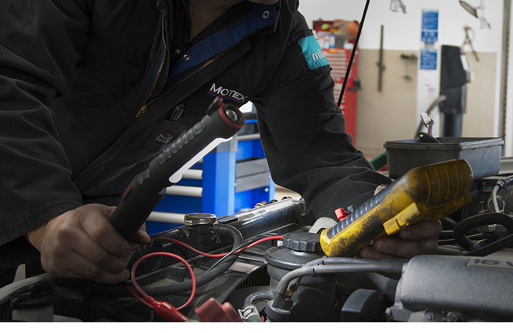 Motex Motors electrician, checking car battery